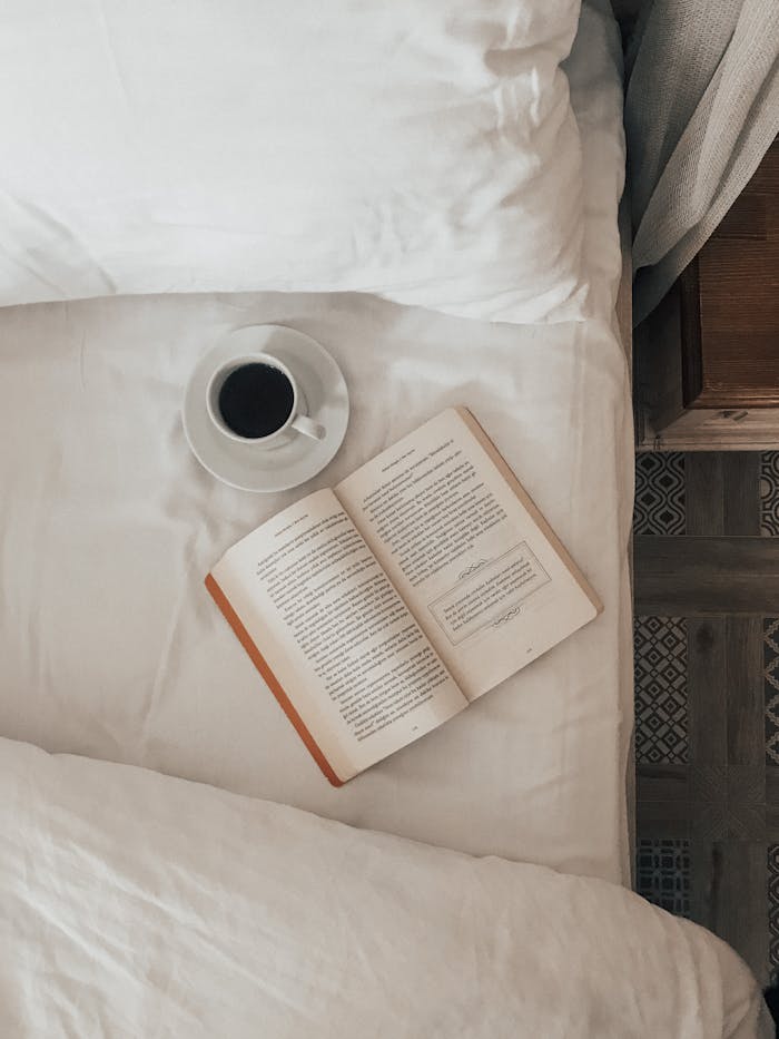 services-04 A calming indoor scene with a book and coffee on the bed, perfect for relaxation and leisure moments.
